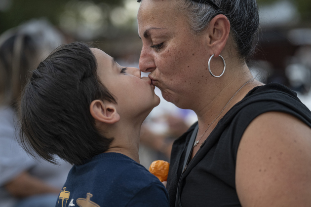 Andrea Fallas and her son J.J., 5, share a tender moment during the National Night Out observance held at the Georgetown Housing Authority’s Stonehaven site  on Tuesday, October 7, 2025.  Photo by Andy Sharp.