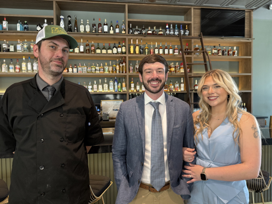 Head Chef Gregory Schwab standing beside restaurant owners Andrew Newport and Hannah Matthews (soon to be Newport). Photo by Abbey Archer