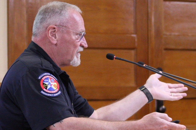 Emergency Management Director Bruce Clements provides an update on clean-up efforts during the Tuesday, October 14, commissioners court meeting. Photo by Nalani Nuylan.