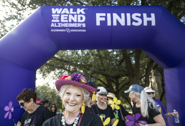 Rowdy Scarborough, a member of the Sassy and Fabulous group from Sun City, smiles as she crosses the finish line during the Walk to End Alzheimer’s, held at Southwestern University on Saturday morning, October 18. 