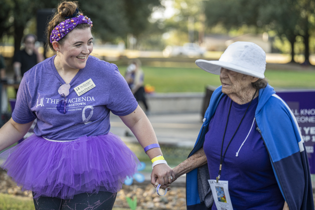 Kaitlyn Fitzgerald, left, senior community life coordinator at Hacienda at Georgetown, walks with Hacienda resident Maria.