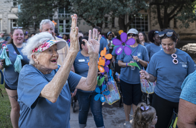 Betty Gresham, 84, an Assisted Living resident at Truewood by Merrill in Georgetown, celebrates as she nears the finish line during  the Walk to End Alzheimer’s, held at Southwestern University on  Saturday morning, October 18, 2025.  The event was coordinated by the Alzheimer’s Association Capital of Texas Chapter.   Photo by Andy Sharp.