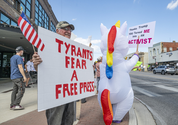 Larry Schmitt holds a sign that says “Tyrants Fear a Free Press” during a “No Kings” demonstration in downtown Taylor on on Saturday afternoon,  October 18, 2025. The crowd was approximately 300, mostly gathered at 2nd and Main Streets.  Photo by Andy Sharp.  