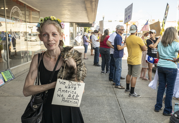 Amy Drake was joined by Gigi, her 7-month-old cat as they walked along Main Street during a “No Kings” demonstration in downtown Taylor on on Saturday afternoon,  October 18, 2025. The crowd was approximately 300, mostly gathered at 2nd and Main Streets.  Photo by Andy Sharp.
