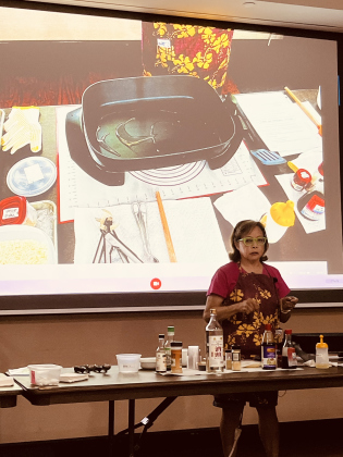 Milana Shydler speaks while she demonstrates how to cook fried rice.