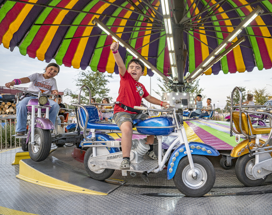 4-year-old August Conley, front right, and his sister Sofia, 6, left, enjoy a carnival ride at the Williamson County Fair on Wednesday, October 22, 2025. Held at the Williamson County Expo Center, the fair and rodeo continues through Saturday.   Photo by Andy Sharp.