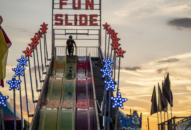 A fair attendee prepares to glide down the Fun Slide at the Williamson County Fair on Wednesday, October 22, 2025. Held at the Williamson County Expo Center, the fair and rodeo continues through Saturday.   Photo by Andy Sharp.