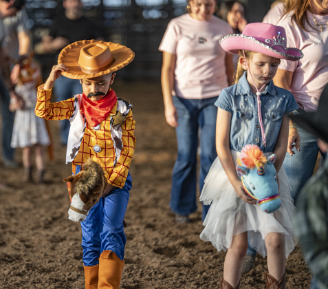 5-year-old Asael  Martinez, left, and Charlotte Prater, right, also 5, take part in the stick horse competition at the Williamson County Fair on Wednesday, October 22, 2025. Held at the Williamson County Expo Center, the fair and rodeo continues through Saturday.   Photo by Andy Sharp.