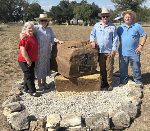 Dinah Dougherty, Claire Legate, Tim Stickley and Don Stickley stand with the historical marker for Perry Cemetery, which was established in 1891 and officially recognized by the state in 2023. They are descendants of the Perry family.