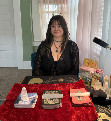 Iza Avalos sits in the reading room at Silver Moon Curios, a metaphysical supply store located at 215 West University Avenue. There is a different psychic giving readings each day of the week. Ms. Avalos is there on Thursdays. Photo by Abbey Archer