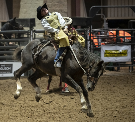 Hunter Greathouse of Santa Fe, Texas competes in Saddle Bronc Riding during the Williamson County Rodeo  on Thursday, October 23, 2025.  The three-night rodeo is held along with the Williamson County Fair at the Williamson County Expo Center.   Photo by Andy Sharp.