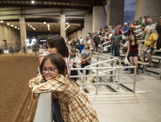 7-year-old Charlotte Escalante, front, and her twin sister Lucy, in back, enjoyed their time together at  the Williamson County Rodeo  on Thursday, October 23, 2025.  The three-night rodeo is held along with the Williamson County Fair at the Williamson County Expo Center.   Photo by Andy Sharp.