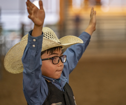 7-year-old Boone Reinke celebrates a first-place win  in Mutton Bustin’ during the Williamson County Rodeo  on Thursday, October 23, 2025. Boone was also the first place finisher in this event.  The three-night rodeo is held along with the Williamson County Fair at the Williamson County Expo Center.   Photo by Andy Sharp.