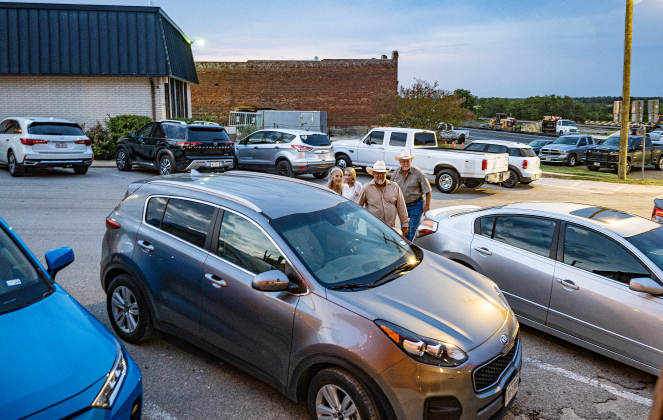 Couples make their way through crowded downtown streets en route to the Coupland Dance Hall on Saturday, August 30, 2025.     Photo by Andy Sharp.