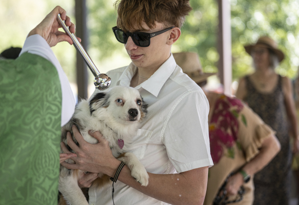 The Reverend Mary Ann Huston, Associate Rector, bestows blessings on Sheila, held by Zack Van Nostrand, 16, during a Blessing of the Animals service conducted by Grace Episcopal Church, held at Booty’s Road Park on Sunday, October 5, 2025.  Lunch was provided at the park’s pavilion after the service acknowledging the work of Saint Francis of Assisi.   Photo by Andy Sharp.