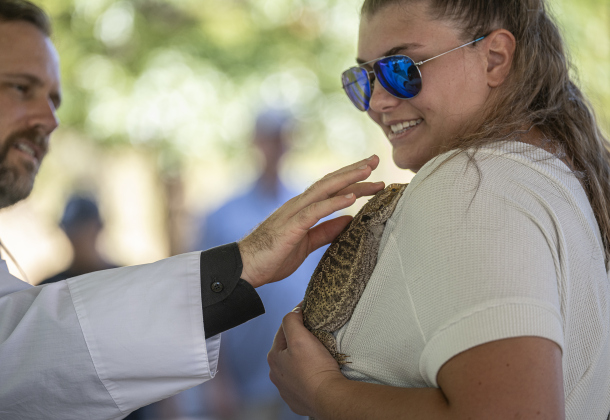 The Reverend Neal McGowan, Rector at Grace Episcopal Church,  bestows blessings on  Zuzu, a Bearded Dragon held by Gloria Kostroun during a Blessing of the Animals service conducted by Grace Episcopal Church, held at BootyÕs Road Park on Sunday, October 5, 2025. ZuzuÕs owner is GloriaÕs sister Ava, who is away at school.   Lunch was provided at the parkÕs pavilion after the service acknowledging the work of Saint Francis of Assisi.   Photo by Andy Sharp.