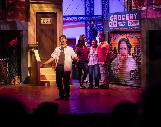 Daniel Ponce, front left, playing Usnavi, is  pictured in a scene from the Thursday, October 2, 2025 dress rehearsal for “In the Heights,” playing on the Palace Springer Stage through November 2nd.  Photo by Andy Sharp.