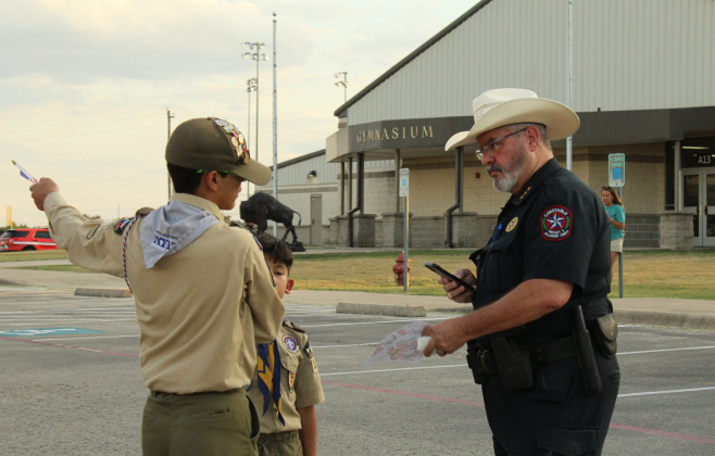 Kevin Wilkie, Williamson County Constable of Precinct 3, talks to some Boy Scouts about how their night is going.