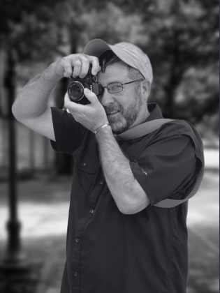 South Main Arts Festival photographer Markus Lindsey takes a photo.