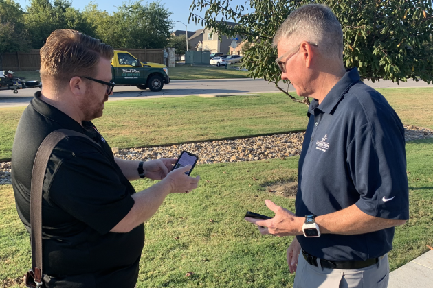 Customer Care Director Seth Gipson, left, and District 7 Councilman Ben Stewart put in a request on the askGTX app about an uneven sidewalk. (Photo by Kaitlyn Wilkes)
