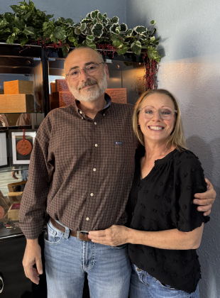Abraham Nimeh (left), Laura Nimeh (right) owners of Aquamation Center Carlson Pet Memorial standing in front of the urn selection. By Abbey Archer