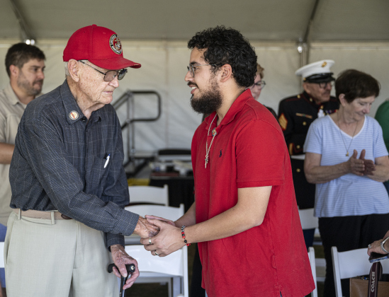 Marine Corps veteran Bill Harrah, 95, left, meets fellow Marine Corps veteran Julian Acosta, 28, right, during a 250th birthday celebration of the United States Marine Corps at the Georgetown Field of Honor in San Gabriel Park  on Saturday, November 8, 2025.