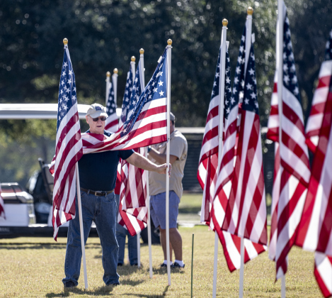 Don Anderson was placing four American flags to honor family members  at the Georgetown Field of Honor in San Gabriel Park  on Saturday, November 8, 2025.
