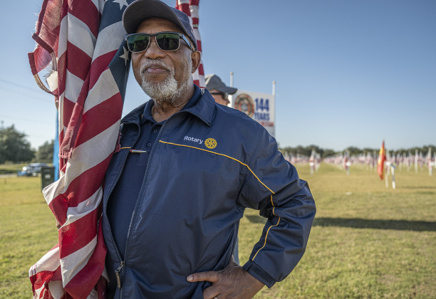 Ron Swain gets ready to place flags honoring his family  at the Georgetown Field of Honor in San Gabriel Park  on Saturday, November 8, 2025.