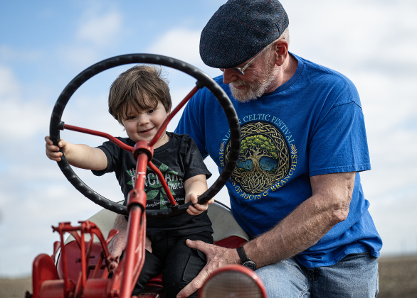  2-year-old Cass Clements, with his grandfather Bruce Clements, tries out an antique Farmall tractor  during Heritage Farm Day, held at the 125-year-old Lutonsky Farm on Saturday, November 15, 2025. 