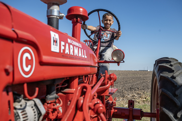 8-year-old Chasen Brown enjoyed sitting astride an antique Farmall tractor during Heritage Farm Day, held at the 125-year-old Lutonsky Farm on Saturday, November 15, 2025.