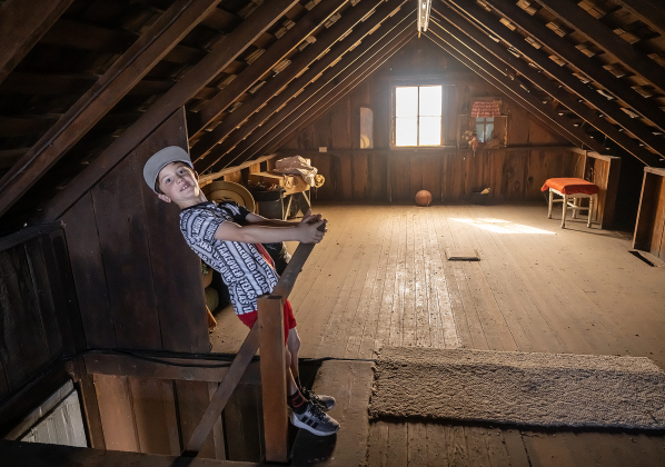 7-year-old Stratton Tullos had fun looking in the spacious attic of the original Lutonsky farmhouse.