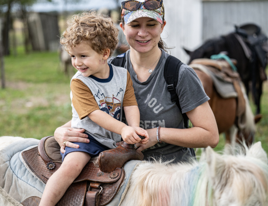 3-year-old Cooper Mikeska, with his mom Kinzy Mikeska, enjoys a pony ride during Heritage Farm Day, held at the 125-year-old Lutonsky Farm on Saturday, November 15, 2025.