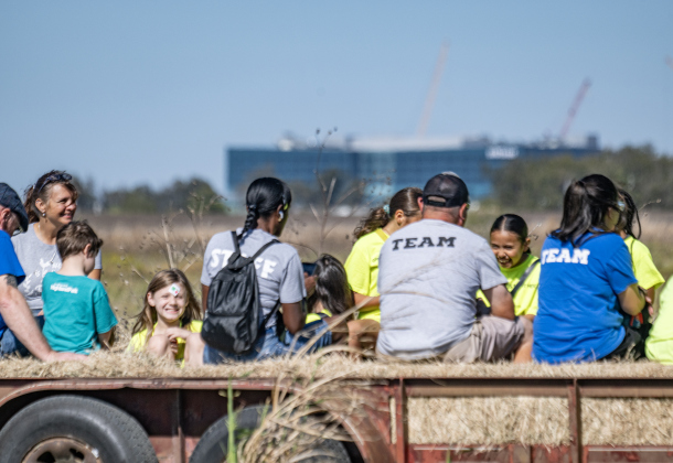 Kids and staff from the Boys &amp; Girls Club of East Williamson County enjoy a hayride during Heritage Farm Day, held at the 125-year-old Lutonsky Farm on Saturday, November 15, 2025. In the distance is the Samsung Semiconductor plant.