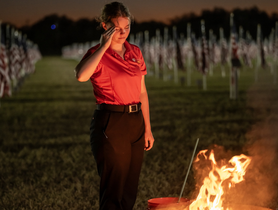 17-year-old Christianna White salutes while overseeing  a flag retirement ceremony at the Field of Honor on Friday, November 14, 2025.  White, along with her mother, Denise White, has taken  part in Field of Honor activities for all of its nine years in Georgetown.  Taking part in the ceremony were members of Scouting America Troop 1096, representatives from the Civil Air Patrol, veterans and active duty military, plus members of the public.  Photo by Andy Sharp.