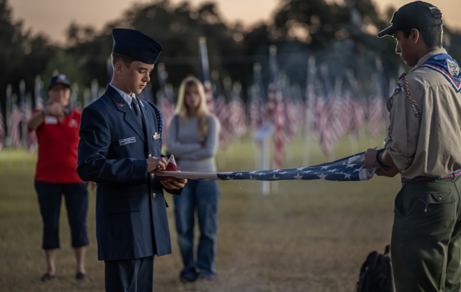 Civil Air Patrol member Trigg Fuller, 14, left, and Corwin Diaz, 17, right, a member of Scouting America Troop 1096,  prepare a flag for retirement during  a flag retirement ceremony at the Field of Honor on Friday, November 14, 2025.  Taking part in the ceremony were members of Scouting America Troop 1096, representatives from the Civil Air Patrol, veterans and active duty military, plus members of the public.  Photo by Andy Sharp.