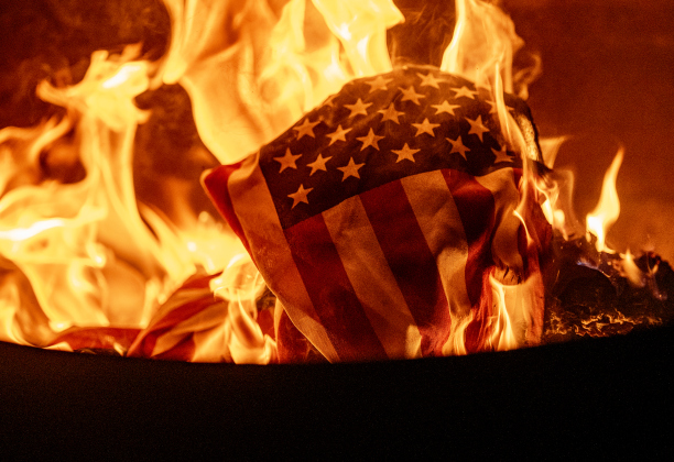 Flames consume a retired flag during  a flag retirement ceremony at the Field of Honor on Friday, November 14, 2025.   Taking part in the ceremony were members of Scouting America Troop 1096, representatives from the Civil Air Patrol, veterans and active duty military, plus members of the public.  Photo by Andy Sharp.