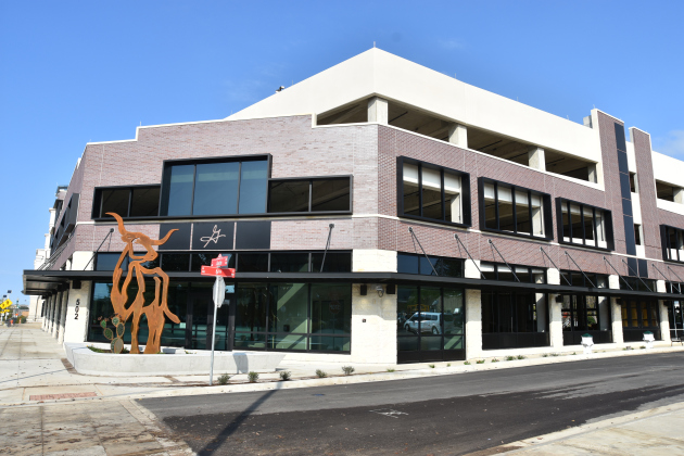 The garage, viewed from Austin Avenue, has a decorative longhorn statue in front of the tourism office entry. Vehicular access is on the Main Street side of the garage. (Photo by Nicholas Cicale)