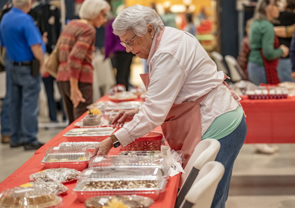 Ruth Jackson arranges baked goods for sale at the 22nd Annual  Come Home for Christmas Celebration held at St. John’s Methodist Church on Saturday, November 22, 2025.  The event included a Youth Cafe, with proceeds going to the St. John’s Youth Ministry.  There was also a silent auction, crafts made by church members, plus a bake sale.   Photo by Andy Sharp.