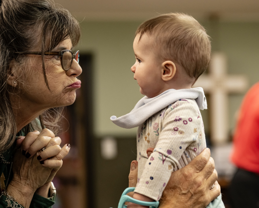 Church member Nancy Bottinger enjoys entertaining her almost 7-month-old granddaughter Alice Wasson while attending the 22nd Annual  Come Home for Christmas Celebration held at St. John’s Methodist Church on Saturday, November 22, 2025.  The event included a Youth Cafe, with proceeds going to the St. John’s Youth Ministry.  There was also a silent auction, crafts made by church members, plus a bake sale.   Photo by Andy Sharp.