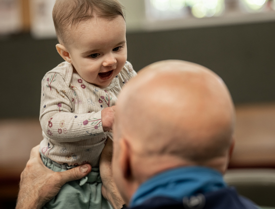 Alice Wasson, almost 7-months-old, has fun spending time with her grandfather Randy Bullard during the 22nd Annual  Come Home for Christmas Celebration held at St. John’s Methodist Church on Saturday, November 22, 2025.  The event included a Youth Cafe, with proceeds going to the St. John’s Youth Ministry.  There was also a silent auction, crafts made by church members, plus a bake sale.   Photo by Andy Sharp.