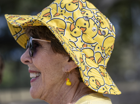 American Association of University Women Member Ruth Pimm wore a duck-themed hat while attending the 10th Annual AAUW Duck Race held on the river at San Gabriel Park on Saturday, November 1, 2025.  Rubber ducks are placed in the river and race to the finish in several heats.  Winners of winning ducks win prizes.   The event raises funds for area high school student scholarships. Photo by Andy Sharp.