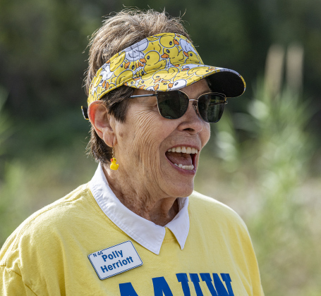 American Association of University Women Member Polly Herriott  wore a duck-themed  visor while attending the 10th Annual AAUW Duck Race held on the river at San Gabriel Park on Saturday, November 1, 2025.  Rubber ducks are placed in the river and race to the finish in several heats.  Winners of winning ducks win prizes.   The event raises funds for area high school student scholarships. Photo by Andy Sharp.