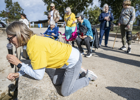 American Association of University Women President Doris Penny oversees the action during  the 10th Annual AAUW Duck Race held on the river at San Gabriel Park on Saturday, November 1, 2025.  Rubber ducks are placed in the river and race to the finish in several heats.  Winners of winning ducks win prizes.   The event raises funds for area high school student scholarships. Photo by Andy Sharp.