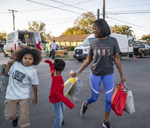 Grace Morton, right, with her children Matthias, 9, and Naomi, 5, received food for her family during the Community Food Drive conducted by Antioch Georgetown on on Sunday, November 2, 2025.