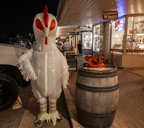 14-year-old Thomas Boyer was dressed as a very large chicken as he spent time around the Georgetown square during Halloween along Main Street on Friday, October 31, 2025.  Photo by Andy Sharp.
