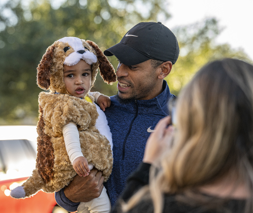 1-year-old Alijah Swindall, dressed as a puppy dog, is pictured with his dad Brendan Swindall as mom Karlee Swindall takes their photo during Halloween along Main Street on Friday, October 31, 2025.  Photo by Andy Sharp.