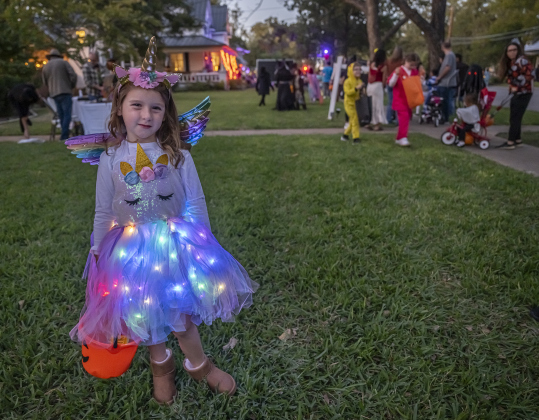 5-year-old Bailey Ulrich wore her lighted unicorn costumer during Halloween along Main Street on Friday, October 31, 2025.  Photo by Andy Sharp. 