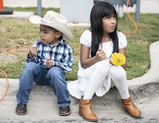 4-year-old Tadeo Ramirez and his sister Samantha, 7, take time to relax during Georgetown’s Dia de los Muertos,  held Saturday November 1, 2025  in the South Main Arts District along 9th Street.  Their sister Sofia, 10, a student at Purl Elementary, performed with the Georgetown ISD Ballet Folklorico.  The event included music and dance performances throughout the day.   Photo by Andy Sharp.