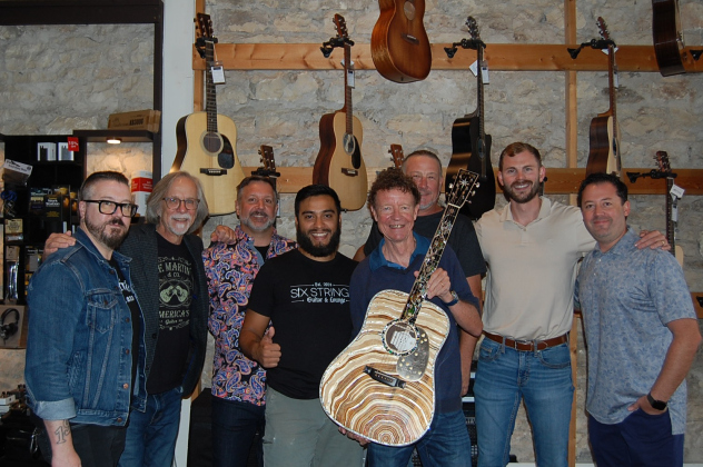 Left to right: Joey O, Craig Thatcher, Colin Besancon, Nick Cruz, C.F. Martin, Duncan Isenhower, Taylor Rountree and Ben Thompkins celebrate the arrival of Martin Guitars at Six Strings Guitar and Lounge on the Square. (photo by Kaitlyn Wilkes)
