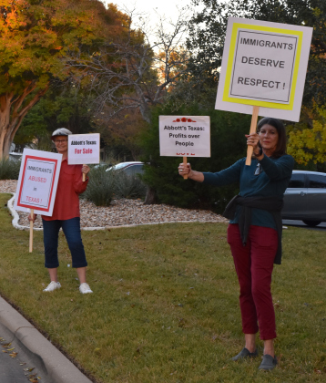 Outside of the event at the Sun City Social Center, a few dozen protesters held signs, including Judy Herwig, right, and Terri Odle. (Photo by Kaitlyn Wilkes)